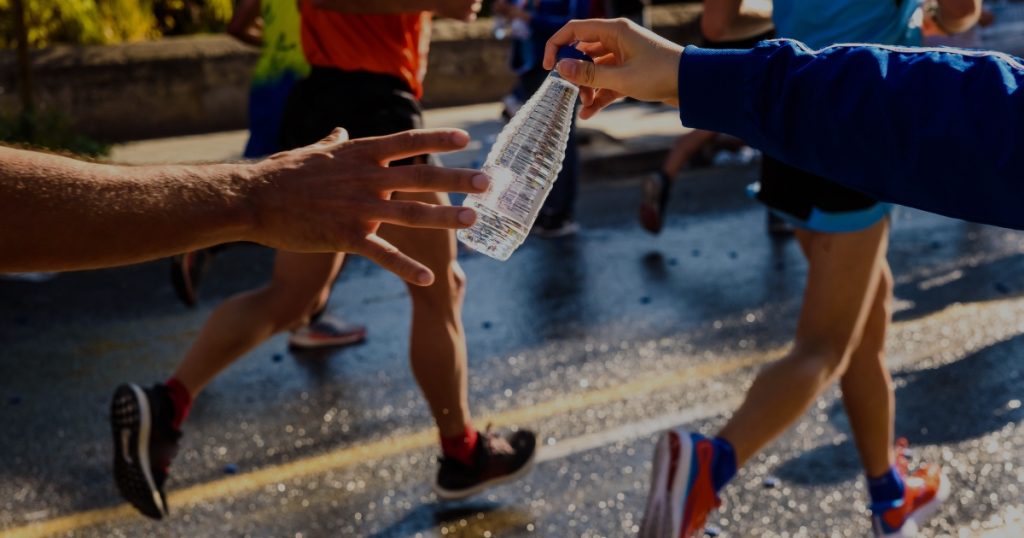 Runner hydrating during a marathon.
